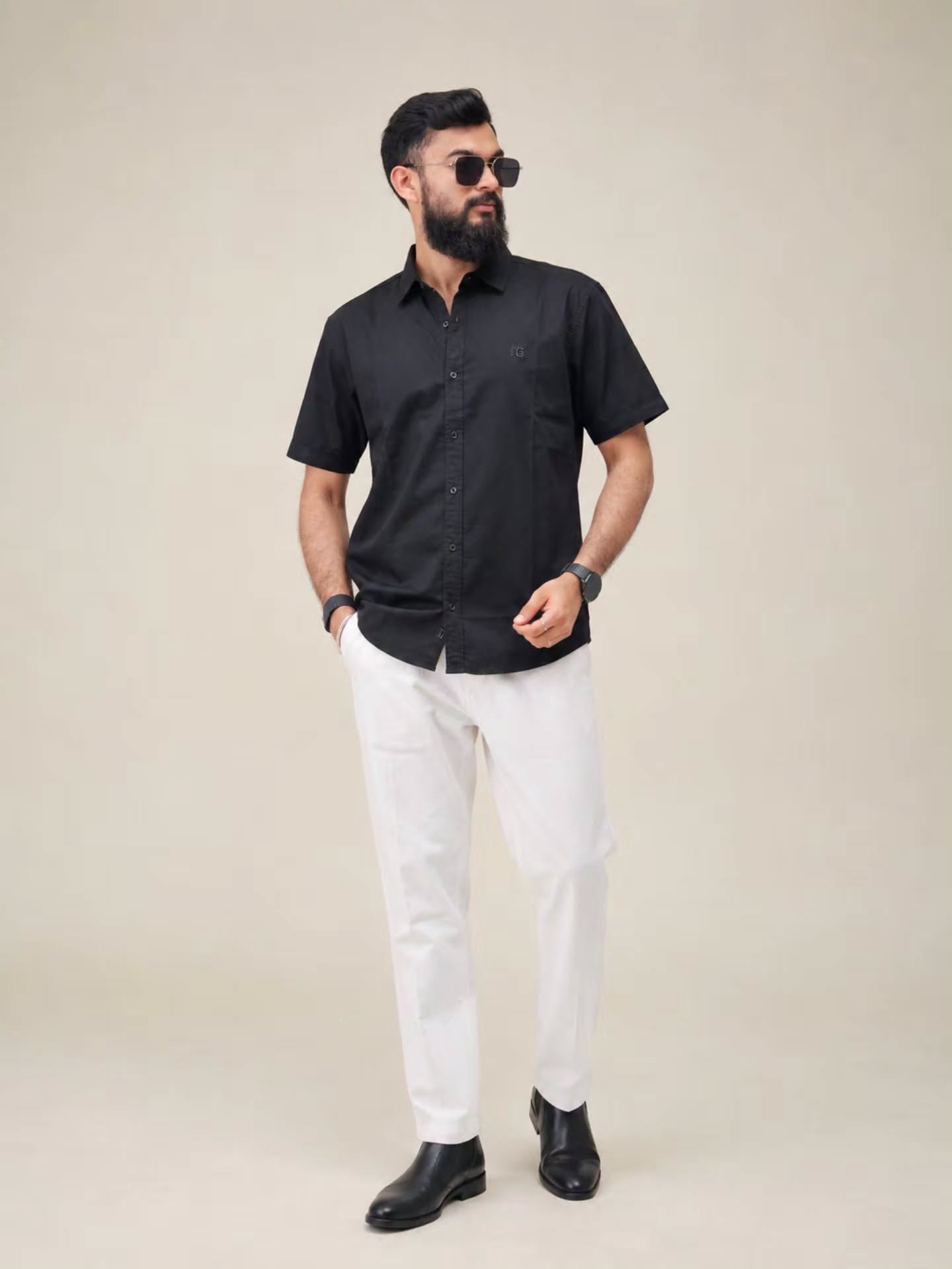 Black short-sleeve shirt with white trousers