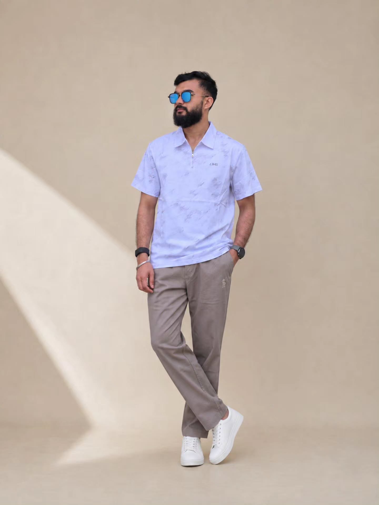 Patterned quarter-zip polo with taupe trousers