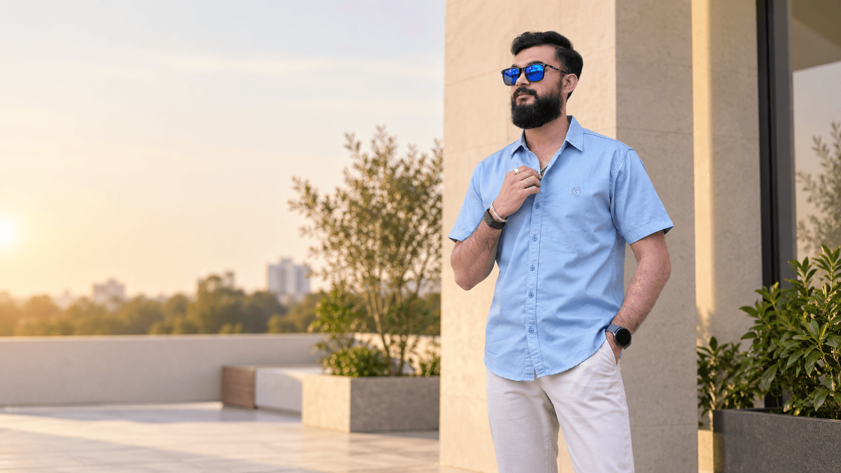 Rajnish wearing a blue short-sleeve shirt and light trousers