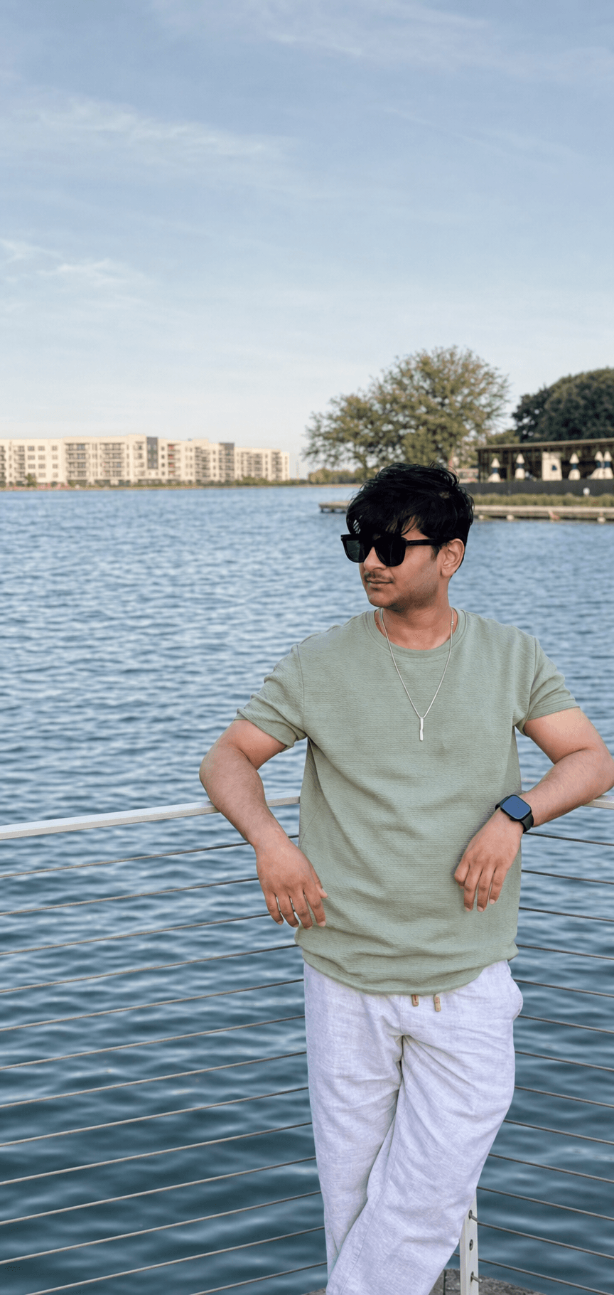 A Vestire customer in a sage green tee by the water
